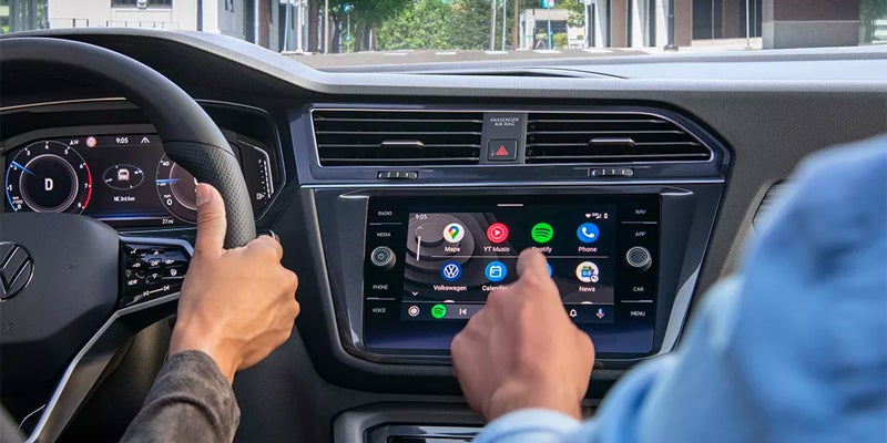 man using infotainment system of Volkswagen Tiguan